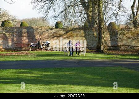 families enjoying the bright autumn sunshine on a very cold day in East Yorkshire, uk, gb Stock Photo