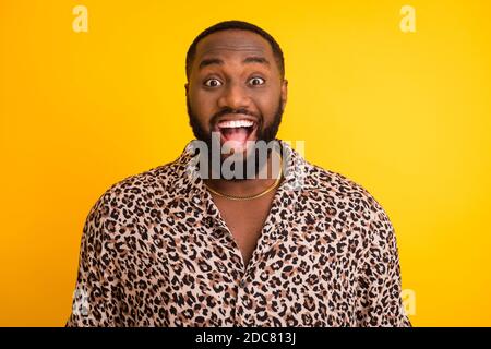 Photo of crazy surprised funny dark skin guy tourist summer vacation trip toothy smile open mouth wear golden chain trend leopard shirt isolated Stock Photo