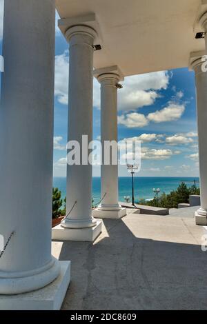Colonnade in Chernomorsk city on a sunny summer day, Ukraine. Black Sea in the background. Stock Photo