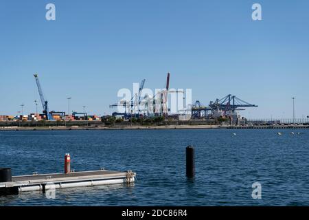 Port of Valencia view with shipping container terminal and cranes.Important harbour in Mediterranean Sea .Industry , transport and business concept ba Stock Photo
