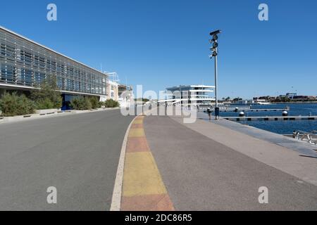 Valencia,Spain-October 11 ,2020:View of America's Cup Building,( VELES E VENTS)and people walking on the old road circuit of Formula 1 Grand Prix of E Stock Photo