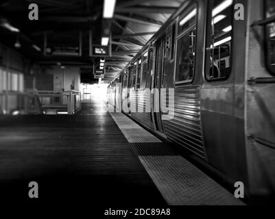 Elevated train pulling away from a station in Chicago. Black and White. Stock Photo