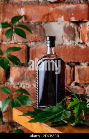 a bottle alcohol on a brick wall background Stock Photo