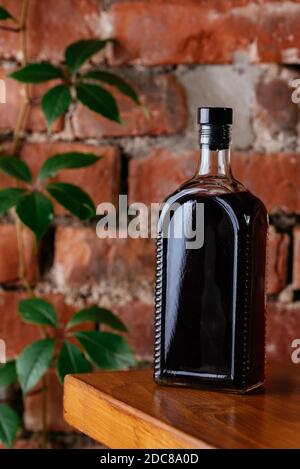 a bottle alcohol on a brick wall background Stock Photo