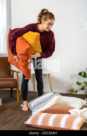 Woman organizes her pillows Stock Photo
