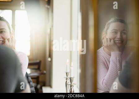 Happy young woman enjoying pleasant conversation with boyfriend in cozy cafe Stock Photo
