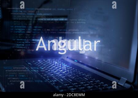 Angular inscription against laptop and code background.  Learning angular programming language. Stock Photo