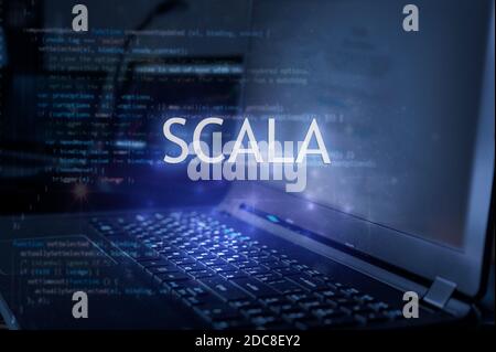 Scala inscription against laptop and code background. Learn scala programming language, computer courses, training. Stock Photo