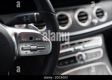 audio control buttons on the steering wheel of the car at shallow depth of field Stock Photo