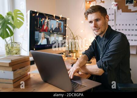 Work from home. Young man having Zoom video call via a computer in the home office. Stay at home and work from home concept during Covid-19 Stock Photo