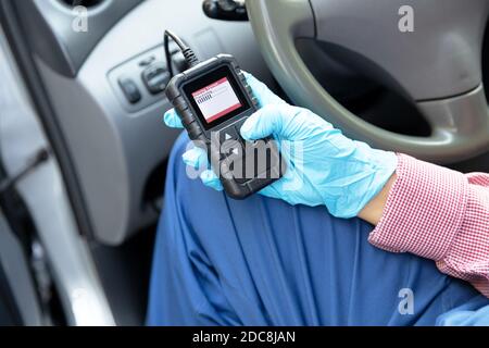 Auto mechanic using car diagnostic scanner tool Stock Photo