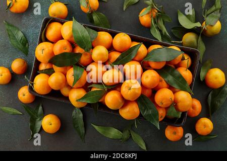 Fresh mandarin oranges with leaves. Seasonal winter fruits for Christmas. Stock Photo