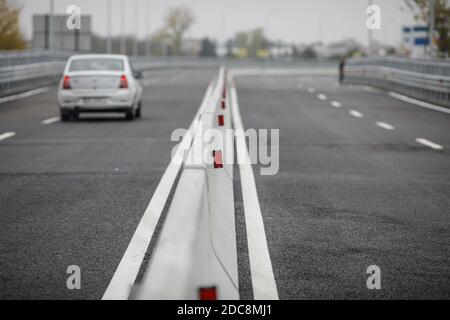 Shallow depth of field (selective focus) image with concrete Jersey barriers (Jersey walls or Jersey bumps) on a highway. Stock Photo