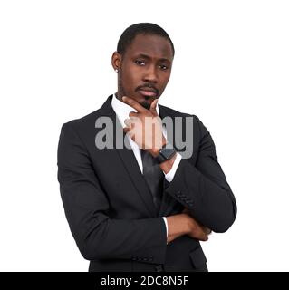 serious African american businessman touching chin wearing black suit isolated on white background  Stock Photo