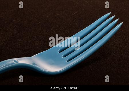 close-up of Colorful plastic eating utensils with dark background Stock Photo
