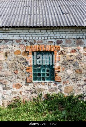 Glass block window in an old stone building Stock Photo