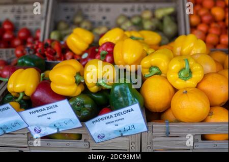 Fresh Organic vegetables and fruits placed mixed on a market stall, names are written in Polish and English Stock Photo