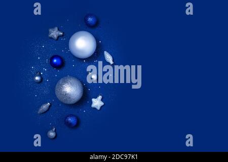 Christmas or New Year baubles with copy space on dark blue background. Greeting card, frame, banner. Flat lay, top view with copy space Stock Photo