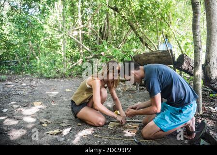Making a fire while camping on Marak Island, a completely deserted tropical island near Padang in West Sumatra, Indonesia, Asia Stock Photo