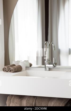 Modern bathroom interior with vanity sink unit, mixer tap, and mirror, UK Stock Photo