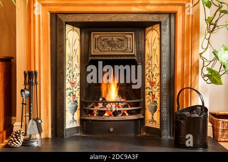 Close up fireplace, traditional Victorian style open fire place burning coal in a UK living room Stock Photo