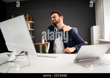Young Man With Tense Shoulder Pain. Office Posture Problem Stock Photo
