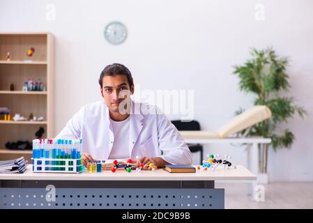 Young male chemist student working in the lab Stock Photo