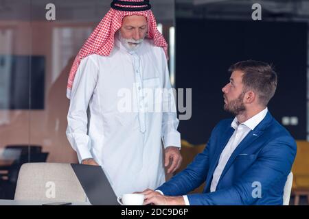 Mature Middle Eastern businessman wearing ghoutra in meeting Stock Photo