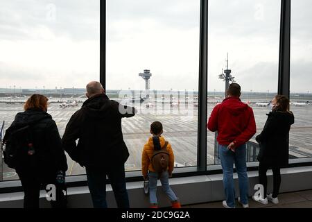 01.11.2020, Schoenefeld, Brandenburg, Germany - Visitors enjoy the view from the visitor terrace of Berlin Brandenburg Airport BER over the apron. Air Stock Photo