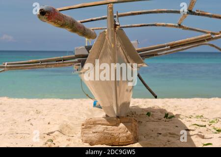 Empty White beach of Boracay island in the daytime. No Chinese tourists because of the coronavirus. A traditional Filipino boat stands on a white beac Stock Photo