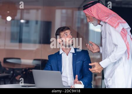 Mature Middle Eastern businessman wearing ghoutra in meeting Stock Photo