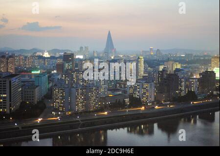 07.08.2012, Pyongyang, , North Korea - Elevated city view with illuminated residential buildings and the Ryugyong Hotel in the center of the North Kor Stock Photo