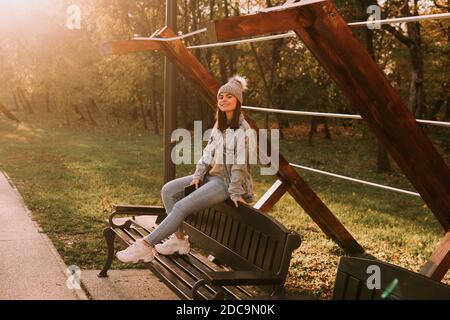 Two friends sitting on a park bench chatting away | Park bench, Fashion  poses, Friend photoshoot