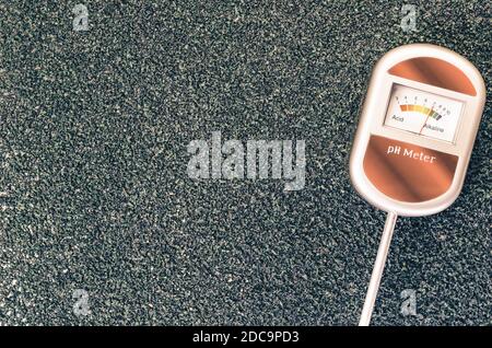 A top view of analog tool to measure soil ph on a rough textured background with copy space Stock Photo