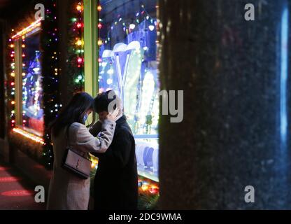 New York, United States. 19th Nov, 2020. Two people put their heads together outside of a display window when Macy's Herald Square Holiday Windows are unveiled with this year's display being designed as a thank you letter to the city and those who were on the frontlines of the coronavirus (COVID-19) pandemic in New York City on Thursday, November 19, 2020. Photo by John Angelillo/UPI Credit: UPI/Alamy Live News Stock Photo