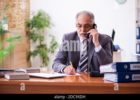 Senior male businessman employee working in the office Stock Photo