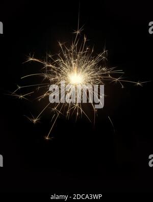 Glittering burning sparkler on black background Stock Photo