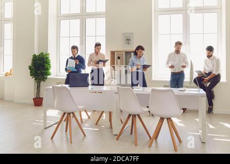 Serious company employees going over their financial reports before corporate meeting Stock Photo