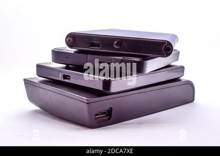 HDD - Stack of Portable Hard Disk Drives isolated on white background. Pile of External hard disk drives. Stock Photo