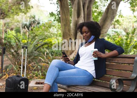 African american woman wearing face mask in street Stock Photo