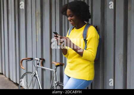 African american woman using smartphone on a street Stock Photo
