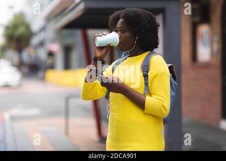 African american woman using smartphone on a street Stock Photo