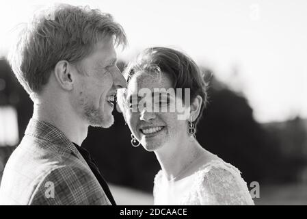 Very nice redhead young just married happy couple kissing in the sunset outdoors Stock Photo