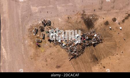 Aerial view of scrapyard. Ecological recycling iron and metal materials from drone view. Background texture concept.