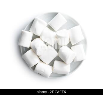 White sweet marshmallows candy on plate isolated on white background. Stock Photo