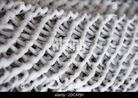 Snow-covered dark grid . Abstract winter black and white background Stock Photo