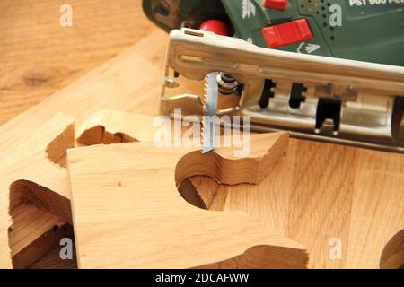 a jigsaw with sawn wood Stock Photo