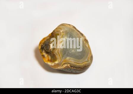 Wild agate stone in warm colors on a white background Stock Photo