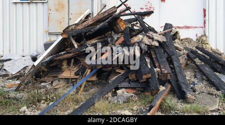 After the fire, a bunch of burnt wooden boards  remained Stock Photo