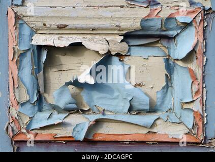 Pieces of old blue cracked paint on the door panel closeup Stock Photo